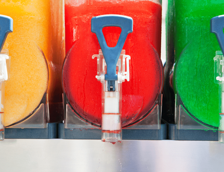 a bunch of different colored drinks in a row