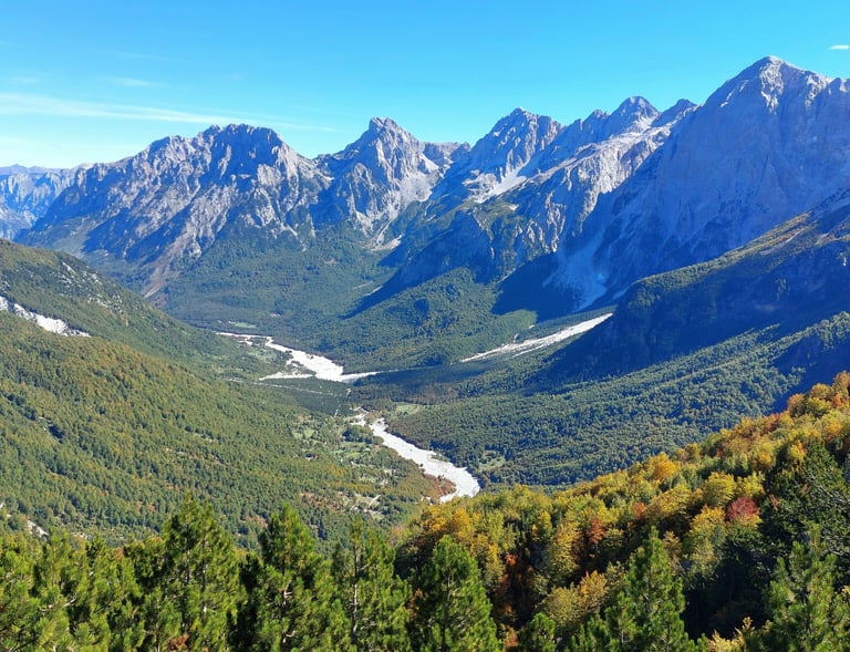 a mountain view of a valley with a river running through it