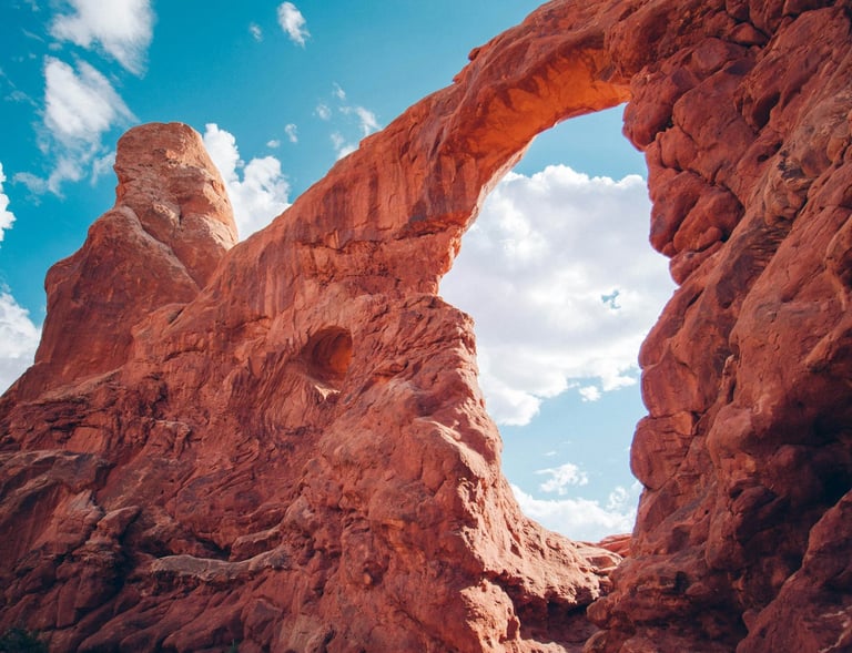 a large arch shaped rock formation in the desert