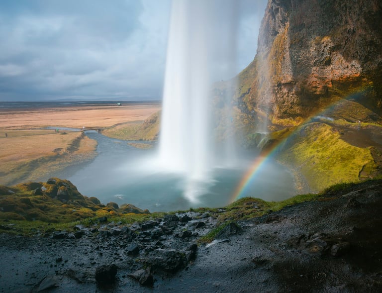 a rainbow over a waterfall