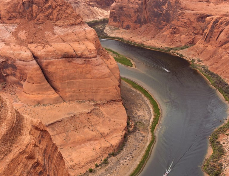 a boat is sailing on the river in the desert