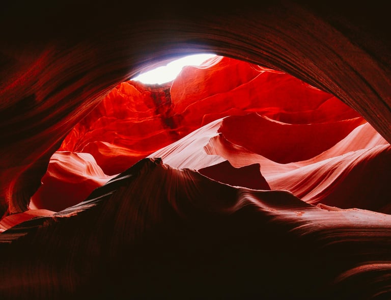 a large red rock formation in the middle of a canyon