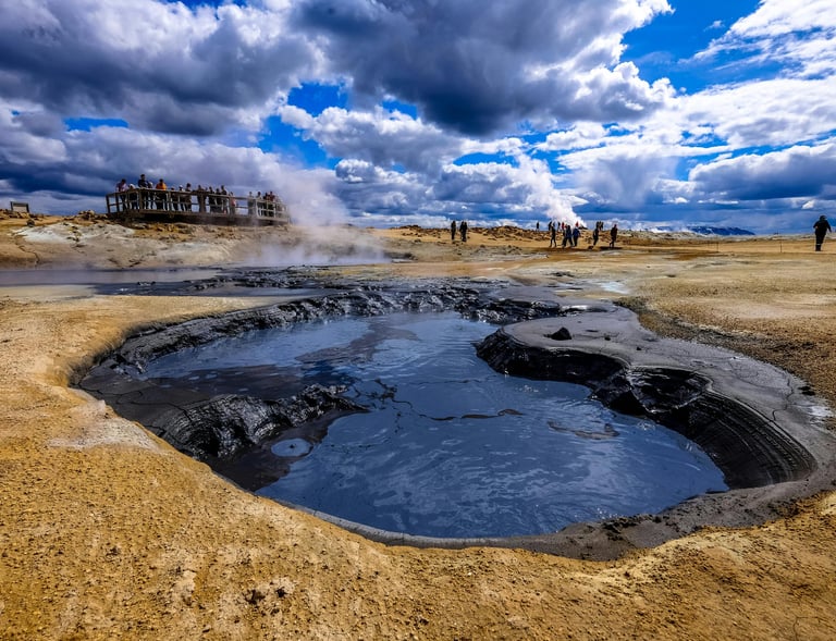 people standing around a small volcano pool