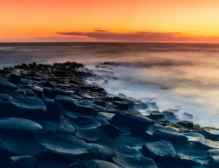 a sunset over the ocean with a view of the ocean