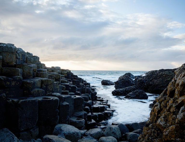 a rocky beach with a view of the ocean
