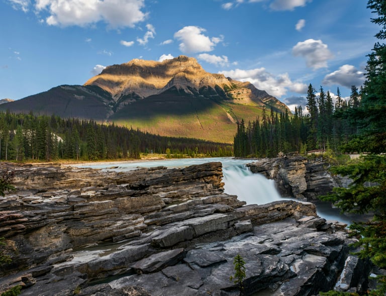 a mountain scene with a waterfall
