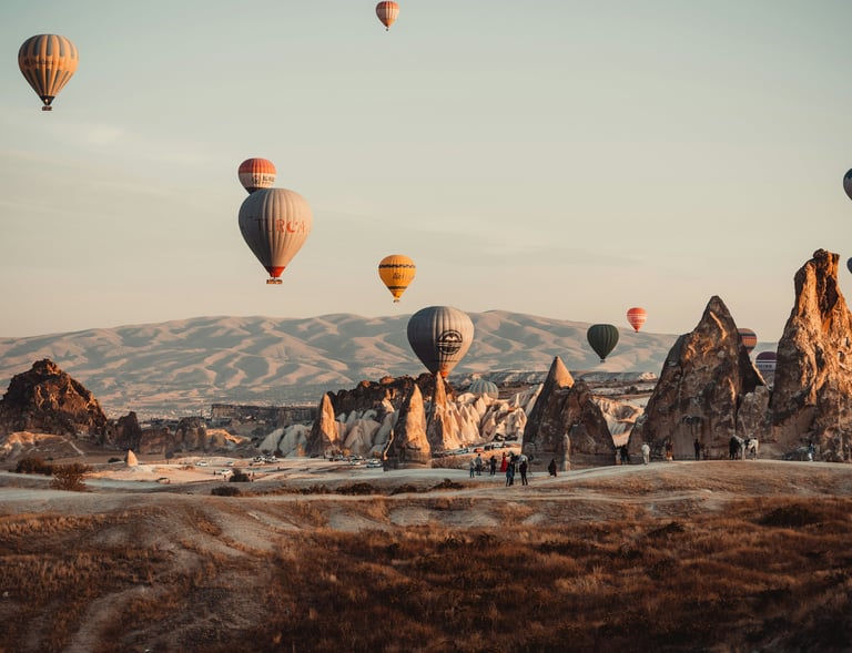 turkey balloons flying over a mountain