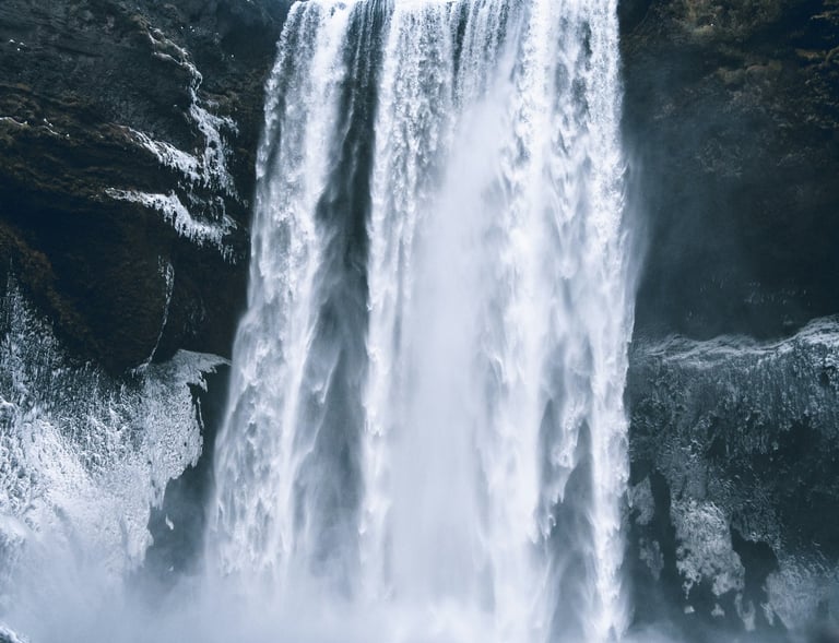 a waterfall in the middle of a mountain
