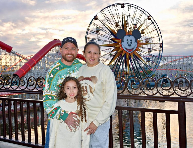 a man and woman standing in front of a ferris wheel