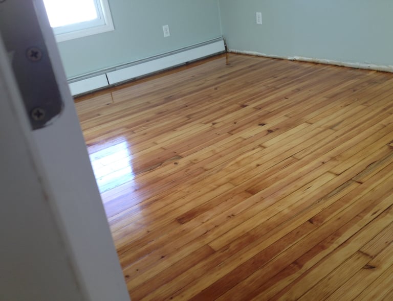 Refinished hardwood floors in bedroom