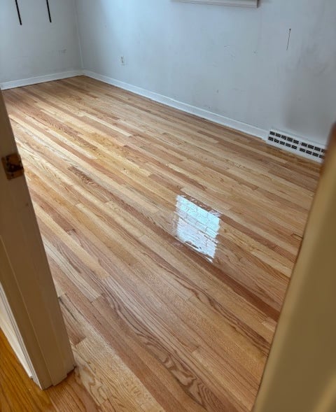Refinished hardwood floors in bedroom