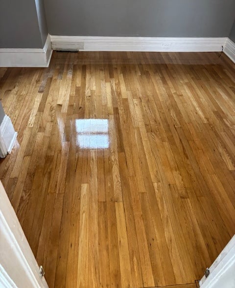 Refinished hardwood floors with repair in bedroom