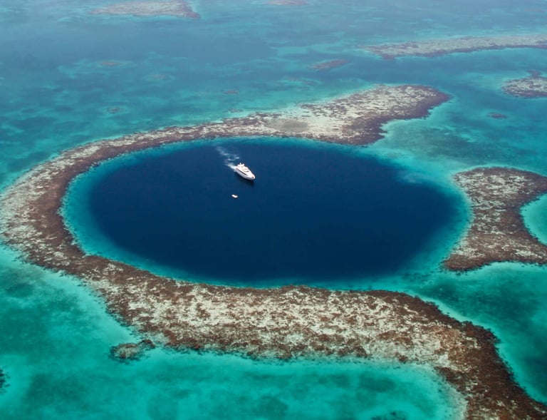 a boat in the middle of a large blue hole