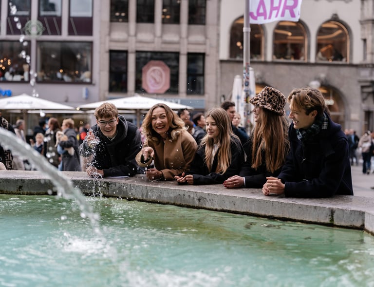 a group of people sitting around a fountain