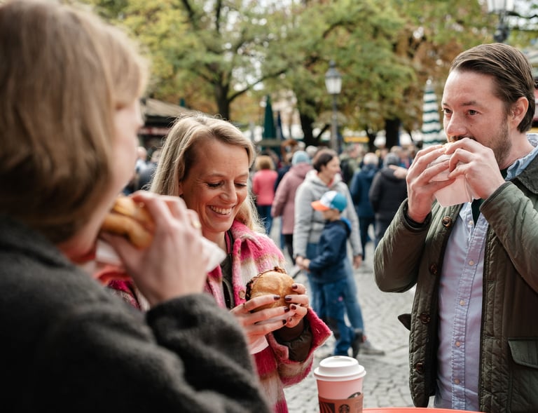a man and woman eating Leberkas in a city