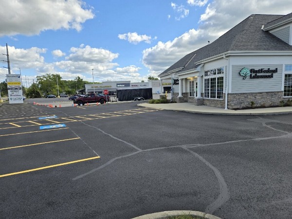 shows a freshly sealcoated and striped bank parking lot in Rocky River
