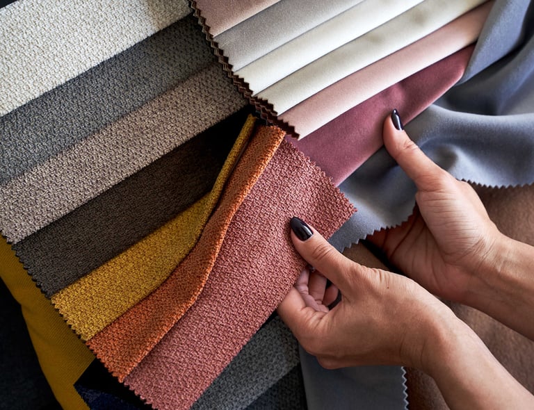 Interior designer Hands checking the quality of textile samples