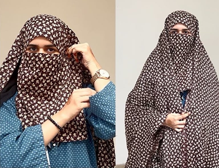 a woman wearing a brown and white chadar and a blue abaya