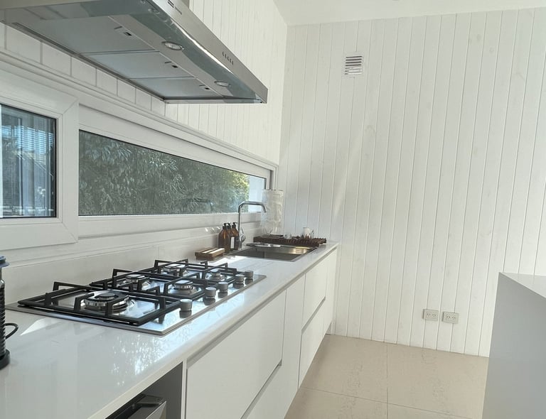 a kitchen with a stove top and a stove top