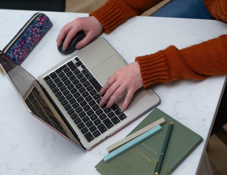 Wirral Brand designer working on brand identity project using MacBook