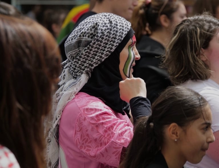 a woman in a pink jacket talking on a cell phone