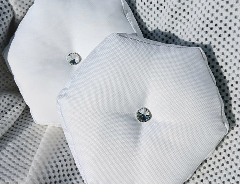A set of luxury hexagonal accent cushions, with diamond like stud in the middle.