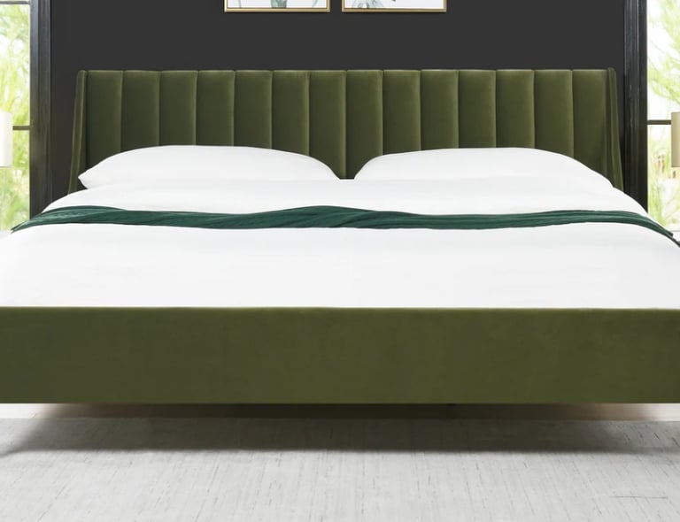Modern olive green velvet platform bed with a channel-tufted headboard and white linens.