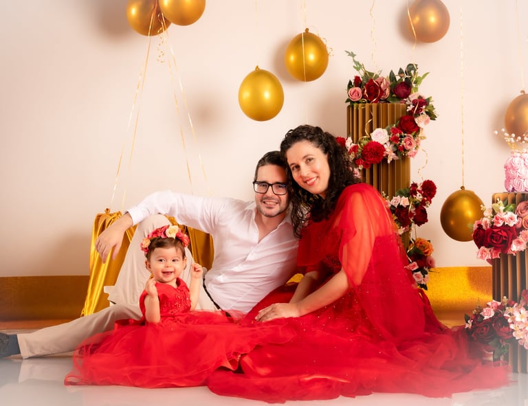 a man and woman sitting on a chair with balloons