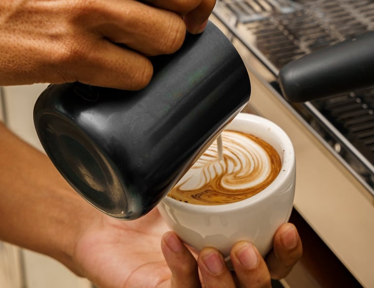 a person is pouring coffee into a cup 