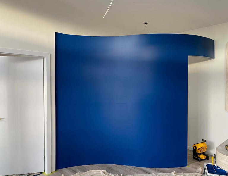 a room with a blue wall and a white door featrue wall 