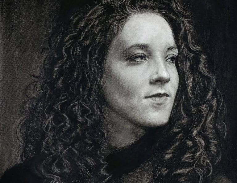 Detailed charcoal and graphite portrait of a woman with curly hair, showing intricate light and shad