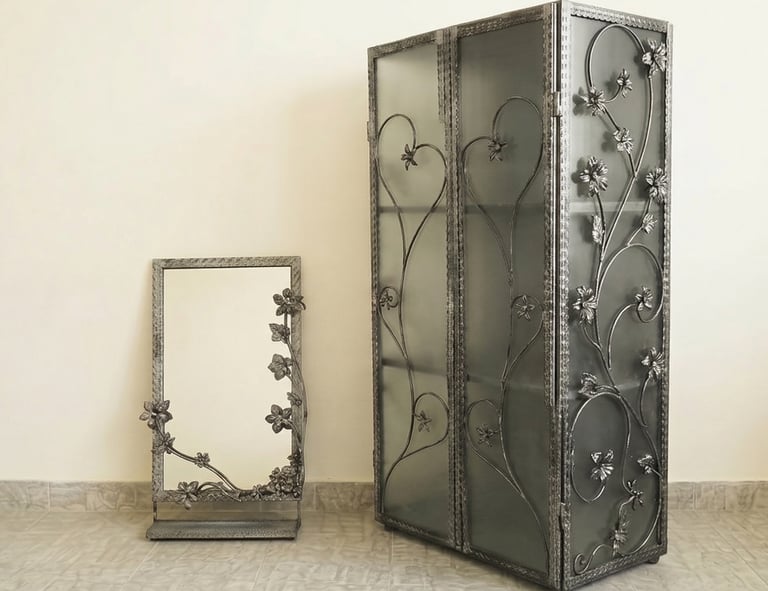 Handcrafted wrought iron cabinet and matching floor mirror with decorative floral metalwork.