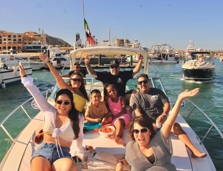 A happy family enjoys a sunny private boat tour in Cabo San Lucas harbor.