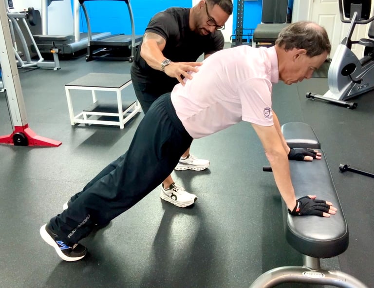fitness coach helping man with push up form