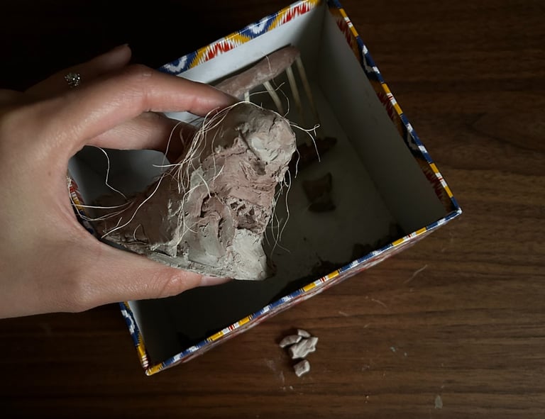 Photo of a broken clay sculpture, resembling fragmented memory and sense of self in older adults.