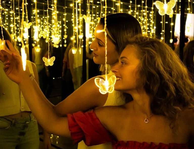 Colleagues bonding in an infinity light room during a creative corporate team building in Split.