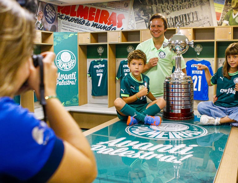 a man and woman in a locker room with a trophy