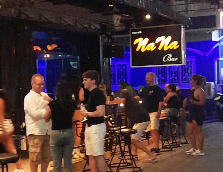 Thai women and bar customers outside bar at Soi 80, Hua Hin in Thailand