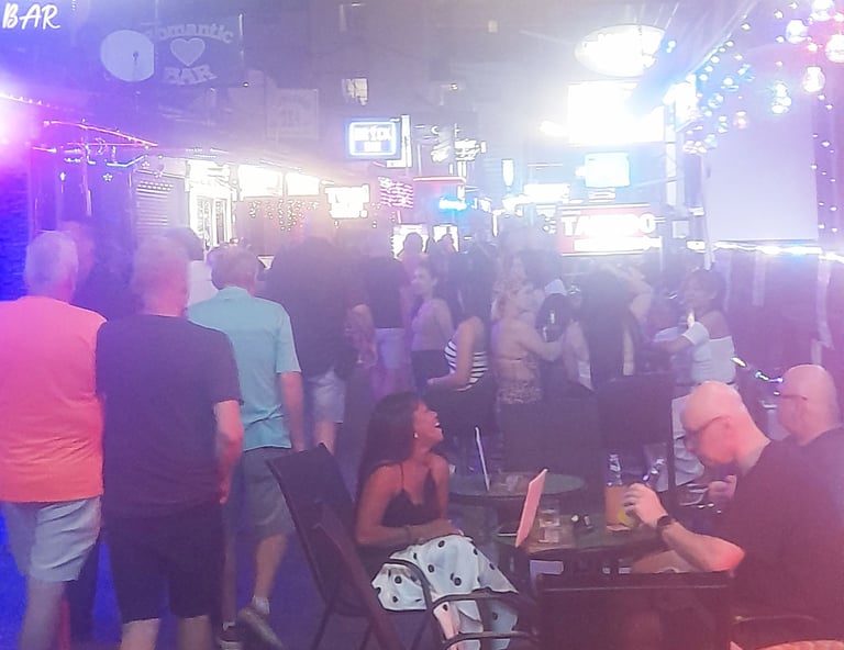 Thai women, tourists and bars on soi Bintabaht, Hua Hin in Thailand