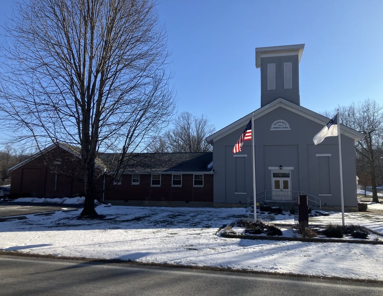 gray country church with american and christian flags