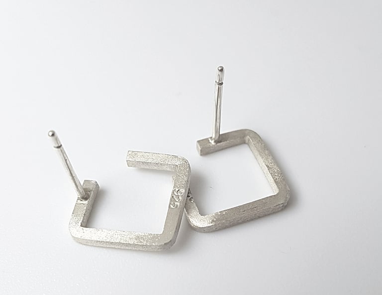 Handmade 925 sterling silver square stud earrings with a brushed matte finish on a white background.