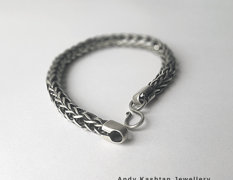 Handmade braided sterling silver chain bracelet with a secure hook clasp on a clean white background.