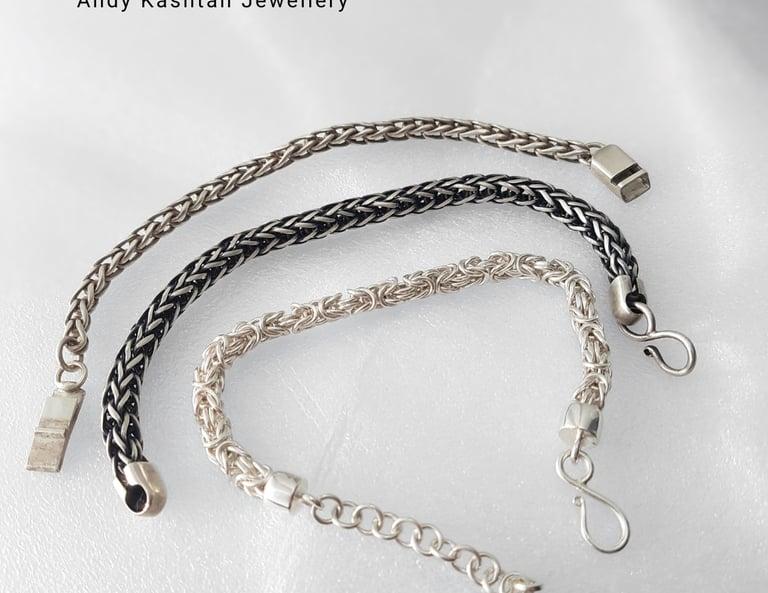 Three handcrafted sterling silver woven chain bracelets by Andy Kashtan Jewellery displayed on a white surface.