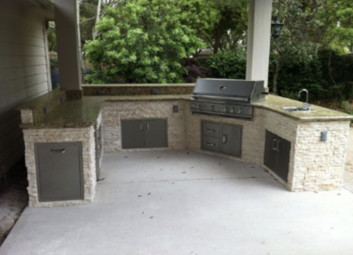 a grilling area with a grill and a grill