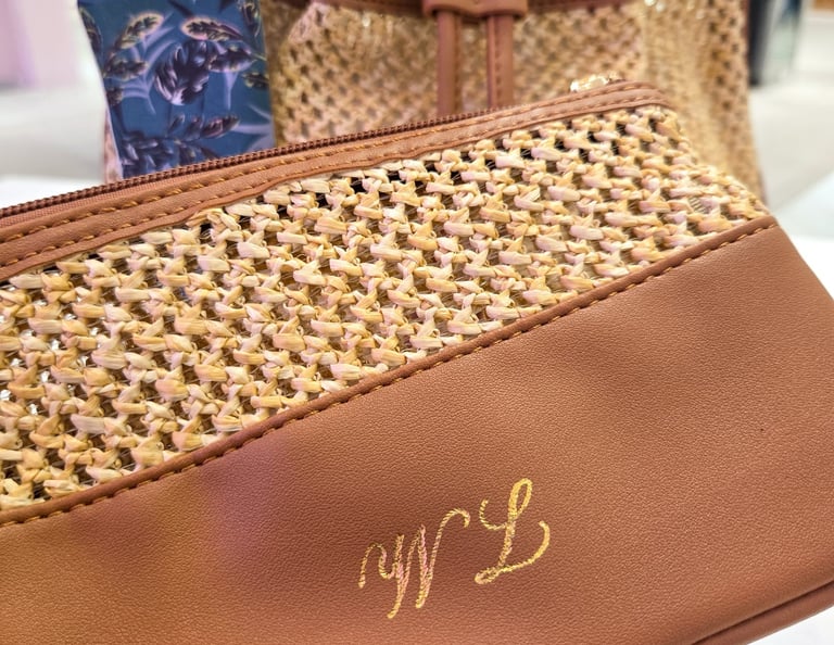 Hot foiling on leather bag at Saks Fifth Avenue by NYC calligrapher Handwritten by Belle.
