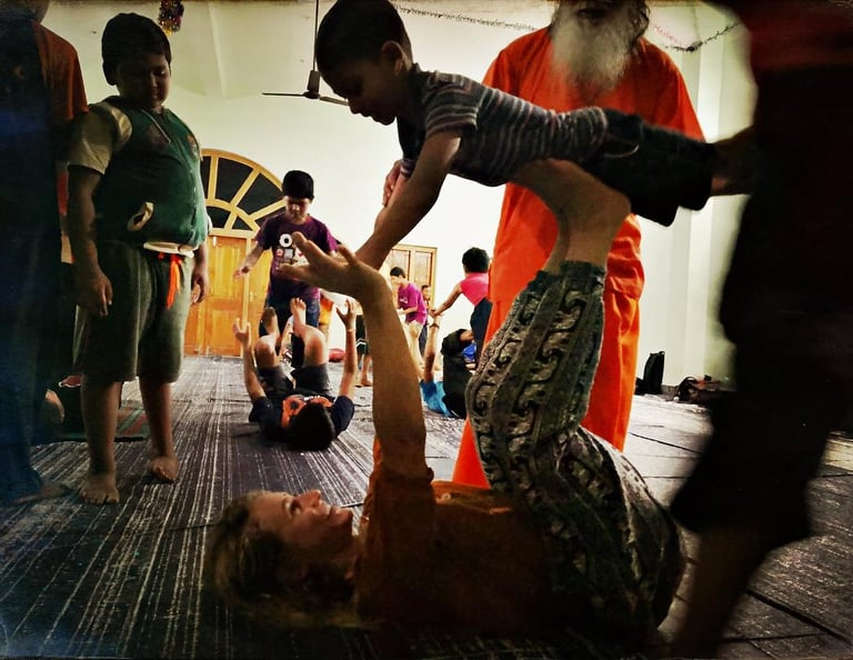 a woman is doing a acroyoga with a kid