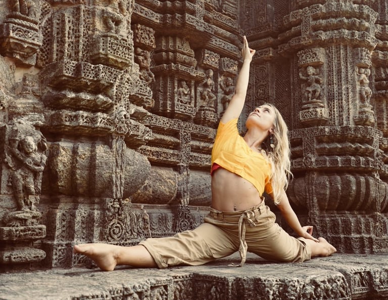 a woman in a yellow shirt is doing yoga in India