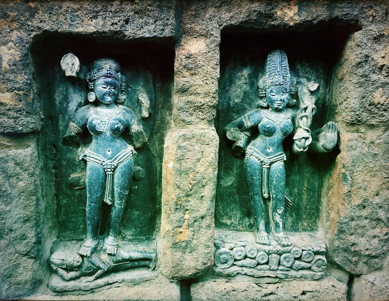 two statues of a woman yogini