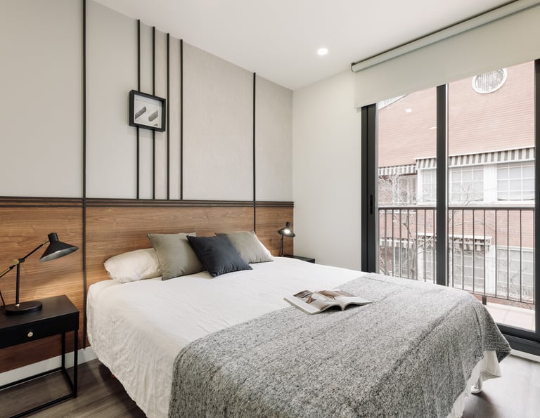 Sophisticated bedroom with natural walnut finishes, custom art pieces, and balanced design by SAVIA