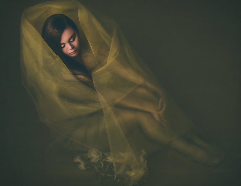 portrait of a girl covered in yellow chiffon fabric